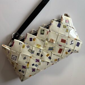 NAHUI OLLIN wrapper ALPHABET upcycled WRISTLET clutch